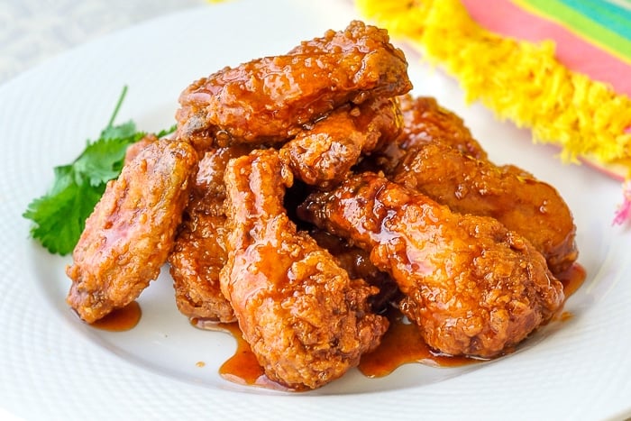 Crunchy-Sticky-Honey-Barbecue-Wings-wide-shot-of-a-white-serving-platter-of-wings